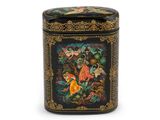 une image représentant une boîte noire et dorée ornée d'oiseaux et de fleurs