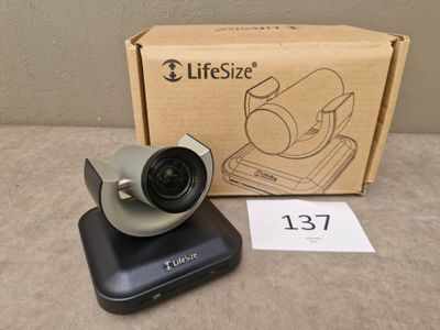 an image of a camera sitting on top of a table next to a box