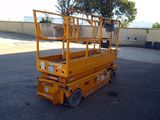 a yellow scissor that is parked in the parking lot