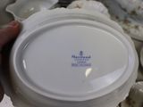 a person holding a white plate with a blue and white logo on it