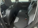 a black car with the door open on the side of the road
