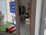 a mannequin in the window of a clothing store