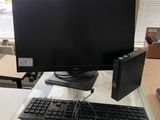 a computer desk with a keyboard and monitor on it