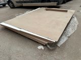 a pile of cardboard sitting on the ground next to a car