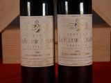 two bottles of wine sitting next to each other on a table