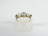 a close up of a gold ring with pearls and diamonds