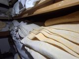 a lot of folded towels on a shelf in a room