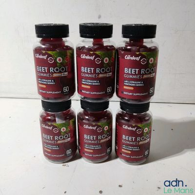 six bottles of beet root sit on a white surface