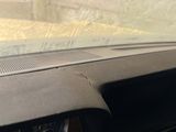 a close up of the dashboard of a car with the sun shining through the windshield