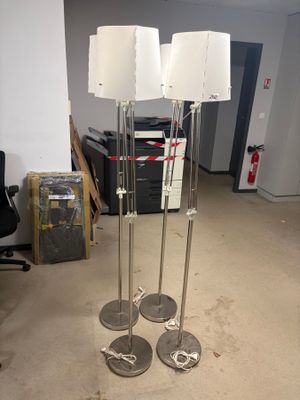 three lamps that are on a stand in a room