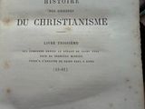 an old book with writing on it sitting on a table