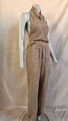 an image of a mannequin wearing a brown dress on a mannequin stand