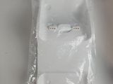 two ear buds sitting in a plastic bag on a table