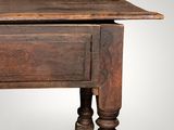 an old wooden table with a drawer on top of it