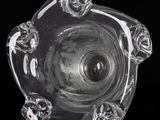 a close up of a glass ashtray on a black background