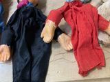 five puppets of people laying on a bed together
