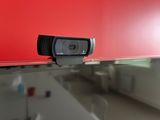 a webcam sitting on top of a glass shelf in a room