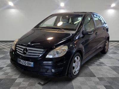 a picture of a black mercedes b - class parked in a garage