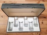 six glasses in a box on a wooden floor