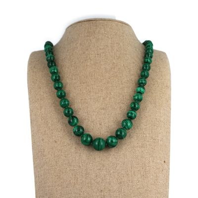 a green beaded necklace on a mannequin mannequin mannequin mannequin mannequin mannequin mannequin mannequin mann