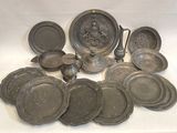 a lot of silver dishes and pans on a table