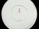 a white plate with a red and white design on it