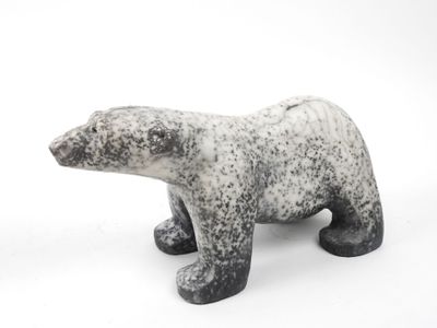 a black and white polar bear figurine on a white background