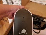 a person holding a mouse in a box on the floor