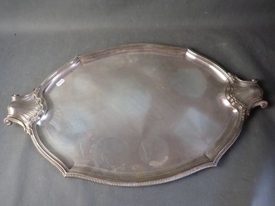 a silver tray with a handle and handles on a table