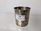 a close up of a silver cup on a glass table