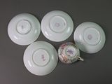 four plates and a teapot are sitting on a table