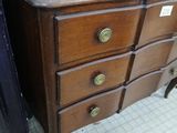 a dresser with a mirror on top of it next to another dresser