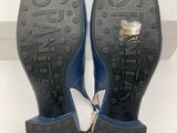 the bottom of a pair of black and blue shoes on a white box