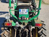 an image of a green tractor parked in a lot
