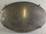 a large metal object on a table with a white background