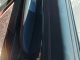 a close up of a car door handle on a red car