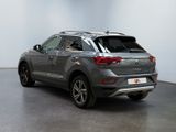 the rear view of a grey volkswagen suv parked in a room