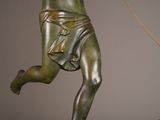 a bronze statue of a man holding a phone
