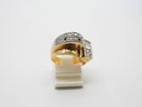 a close up of a gold and diamond ring on a white surface