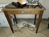 a wooden table with a hat on top of it