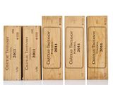 four wooden boxes of wine are lined up on a white surface