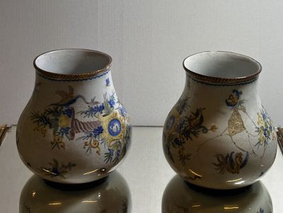 two vases that are sitting on a glass table