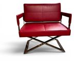 the red leather chair is sitting on a metal frame