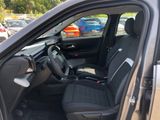 the interior of a car with the door open and the driver ' s seat up