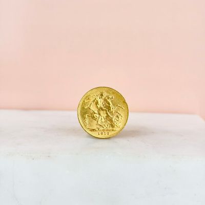 a gold coin sitting on top of a marble slab