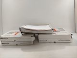 several boxes of books stacked on top of each other on a table