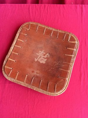 a brown leather tray on a pink table cloth