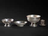 four pieces of silverware including a bowl, cup, and saucer