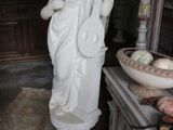 a statue of a woman holding a basket of fruit