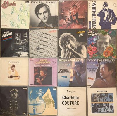 many different album covers on the wall of a room